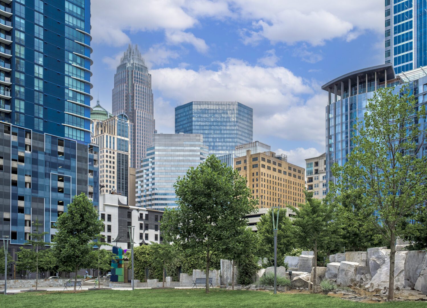 City skyline with trees and blue sky.