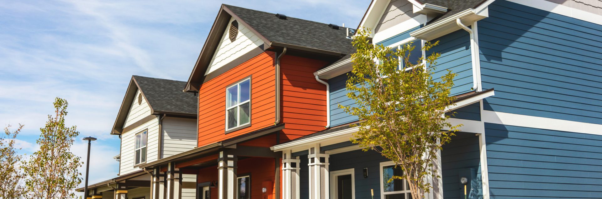 Colorful modern houses under blue sky.