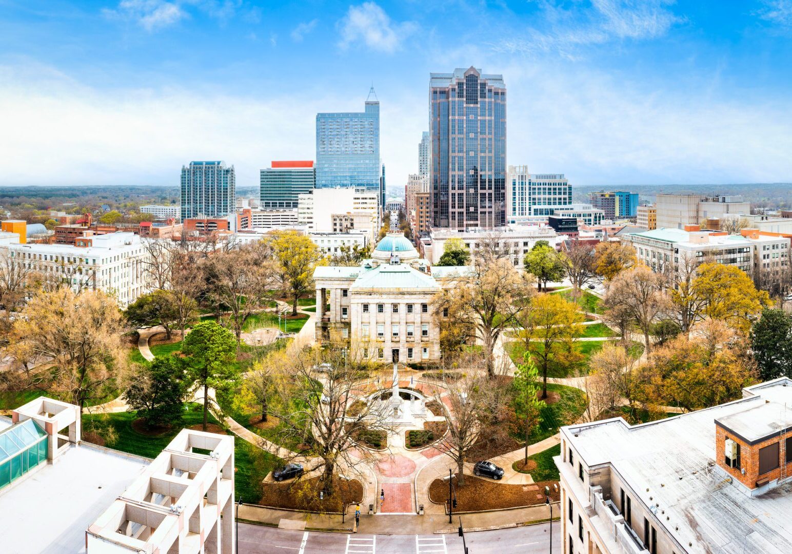 City skyline with trees and historic building.